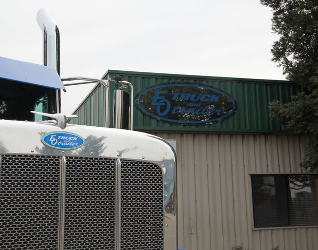 EO Truck and Trailer logo on front of Peterbilt truck